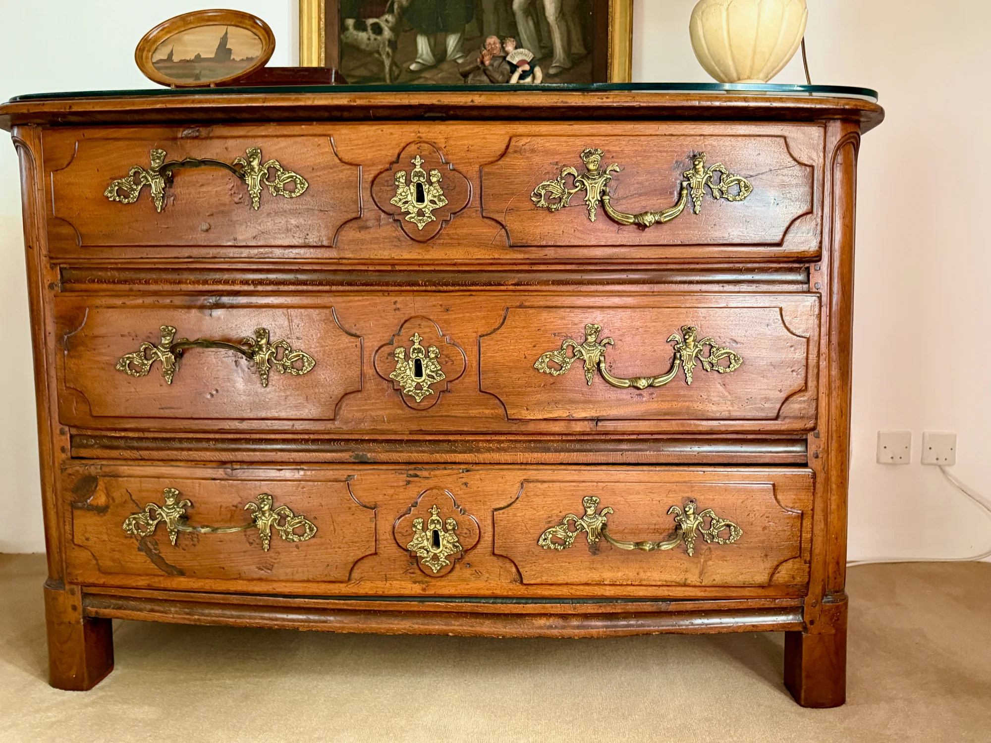 An antique oak commode with bronze hardware at Moulin à Rêves