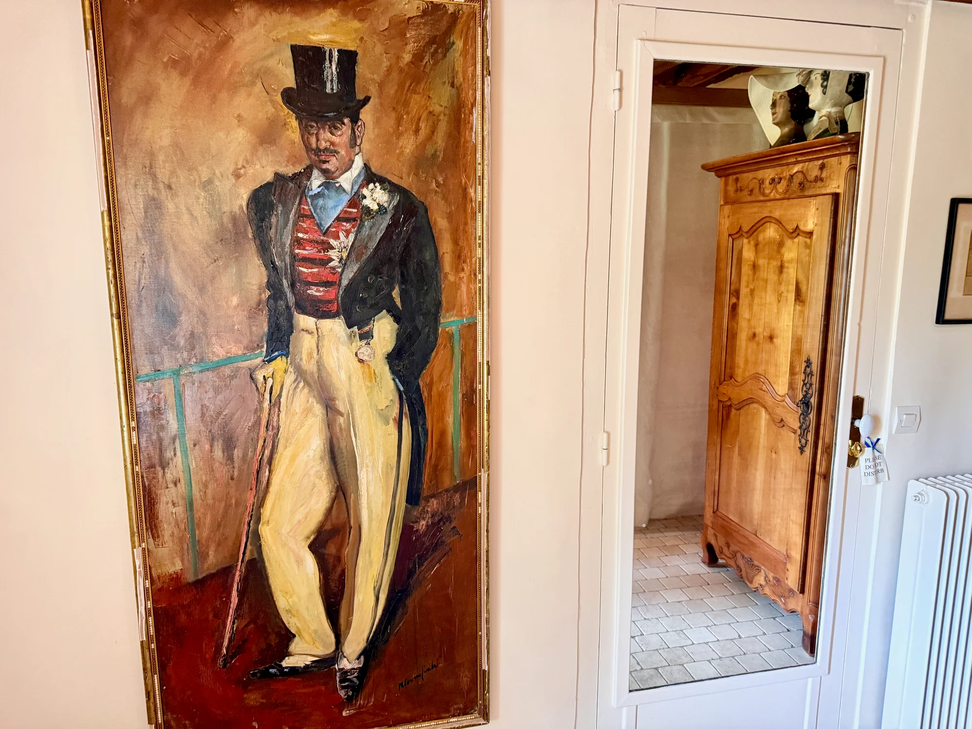 An oil portrait of a man in a top hat at Moulin à Rêves