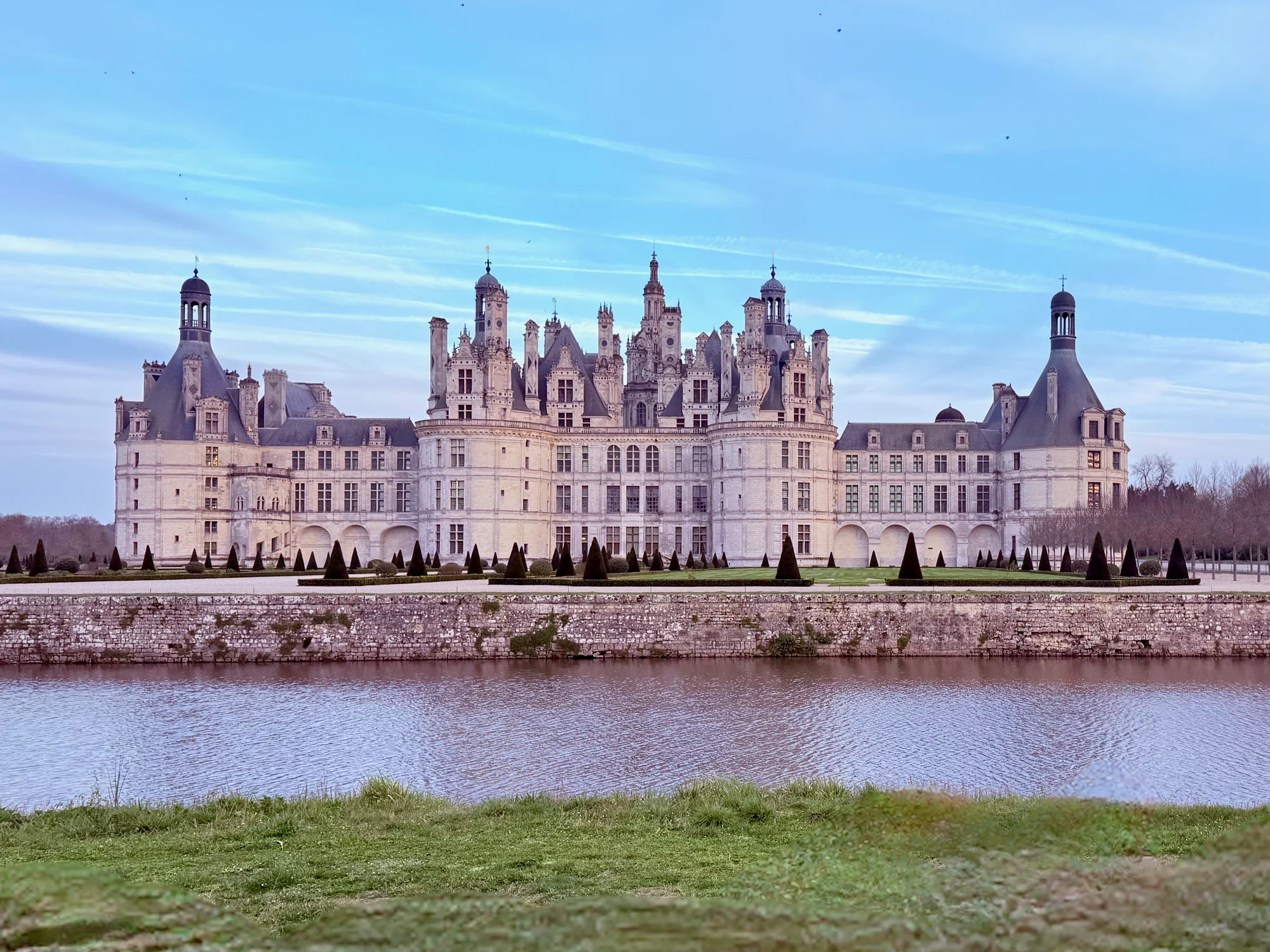 Château de Chambord Renaissance facade reflected in the canal, in the Loire Valley