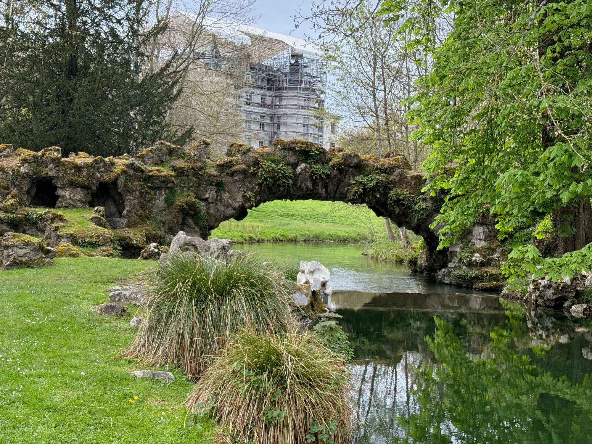Grotto, rock-arch bridge, and stream in the gardens of the Domaine de Méréville