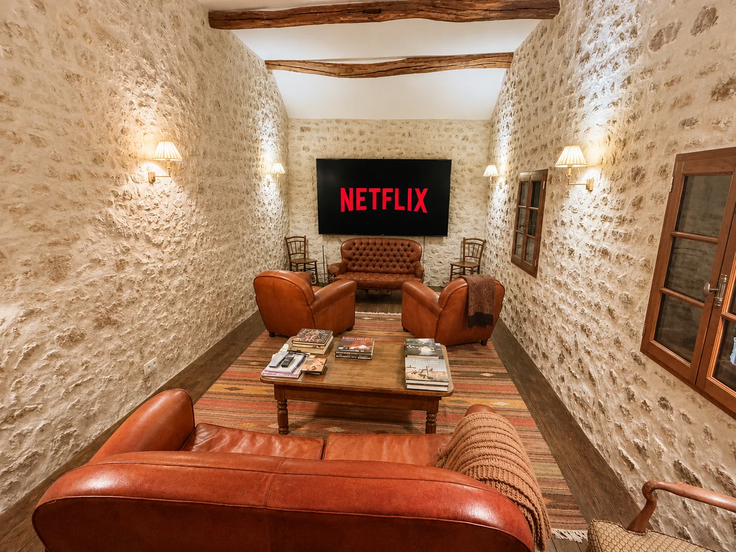 Screening room at La Grange with Netflix on the large screen and leather sofas