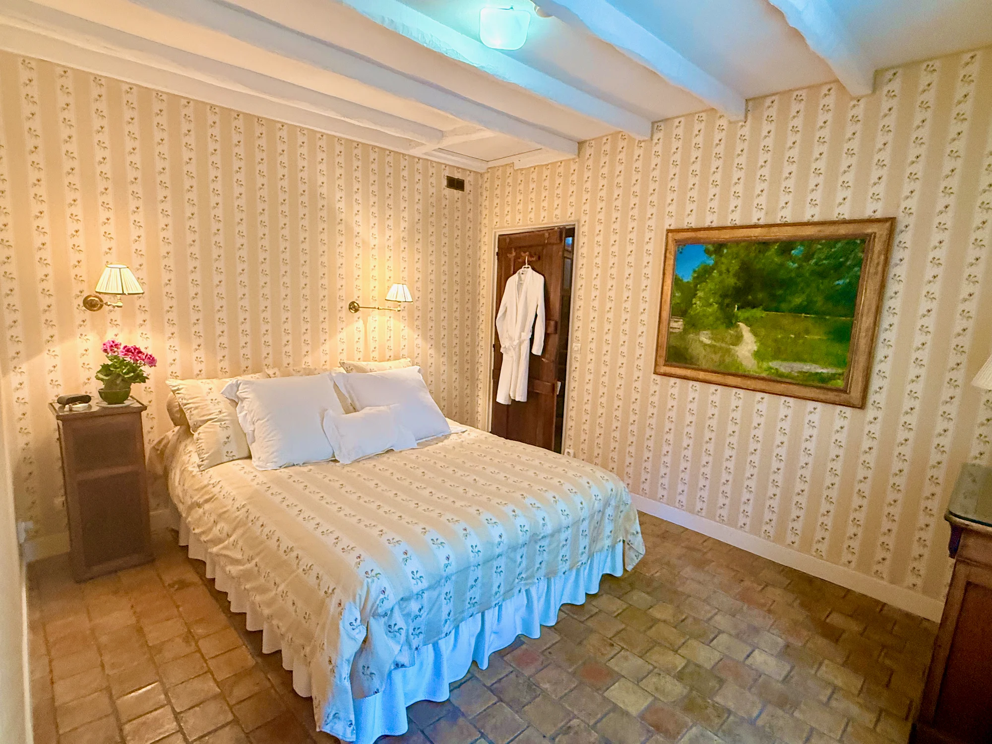 An American in Paris queen bedroom with French wallpaper at The Hollywood Hideaway