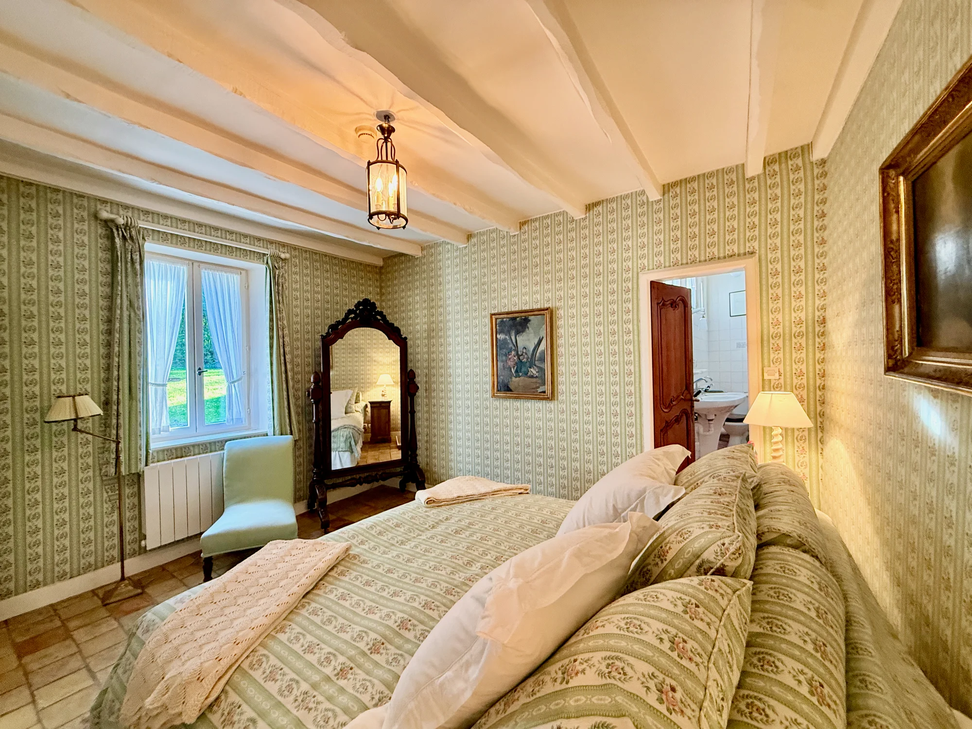 Through the Looking Glass king bedroom with antique mirror at The Hollywood Hideaway