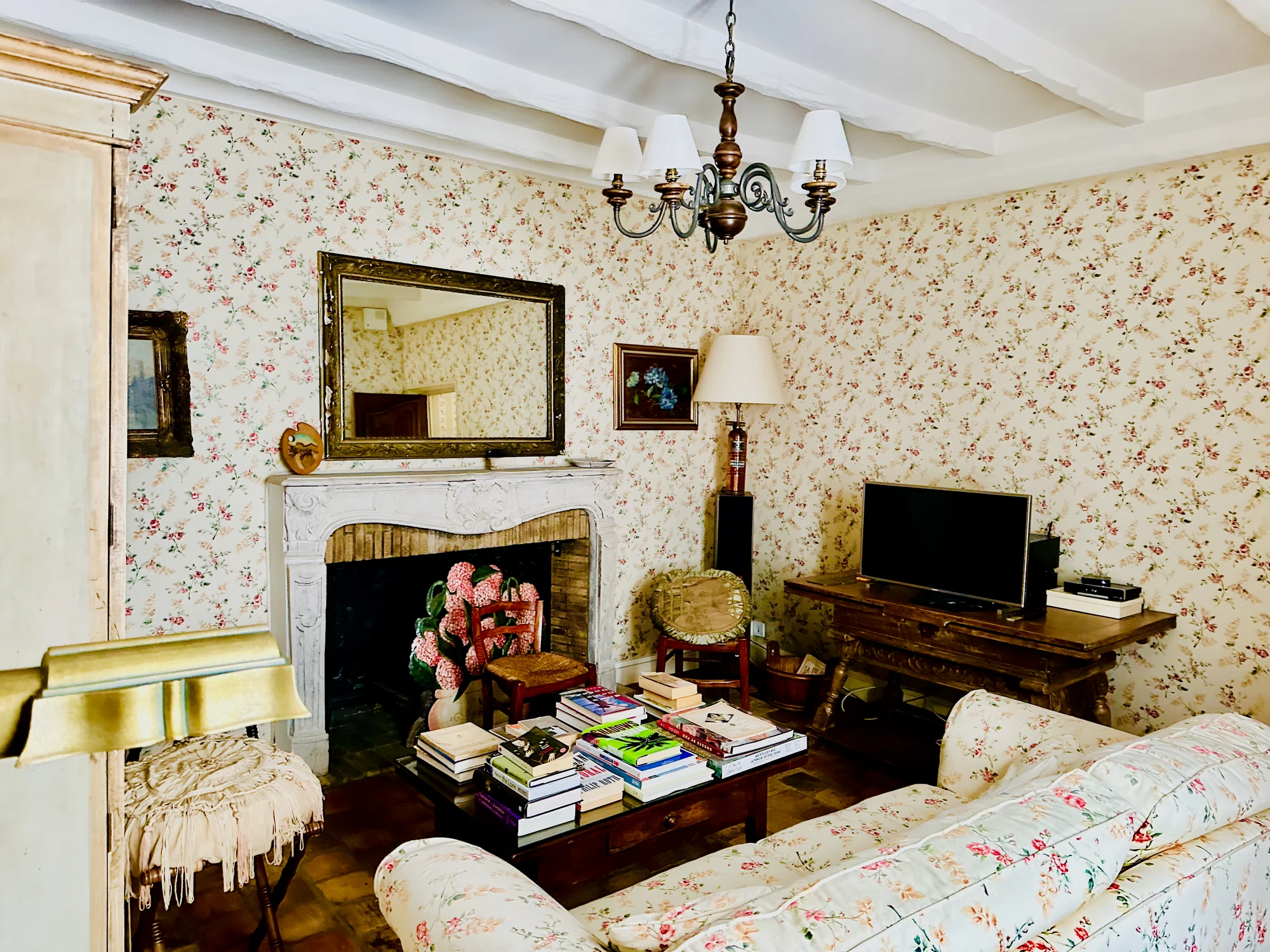 The Secret Garden suite sitting room with floral wallpaper and fireplace