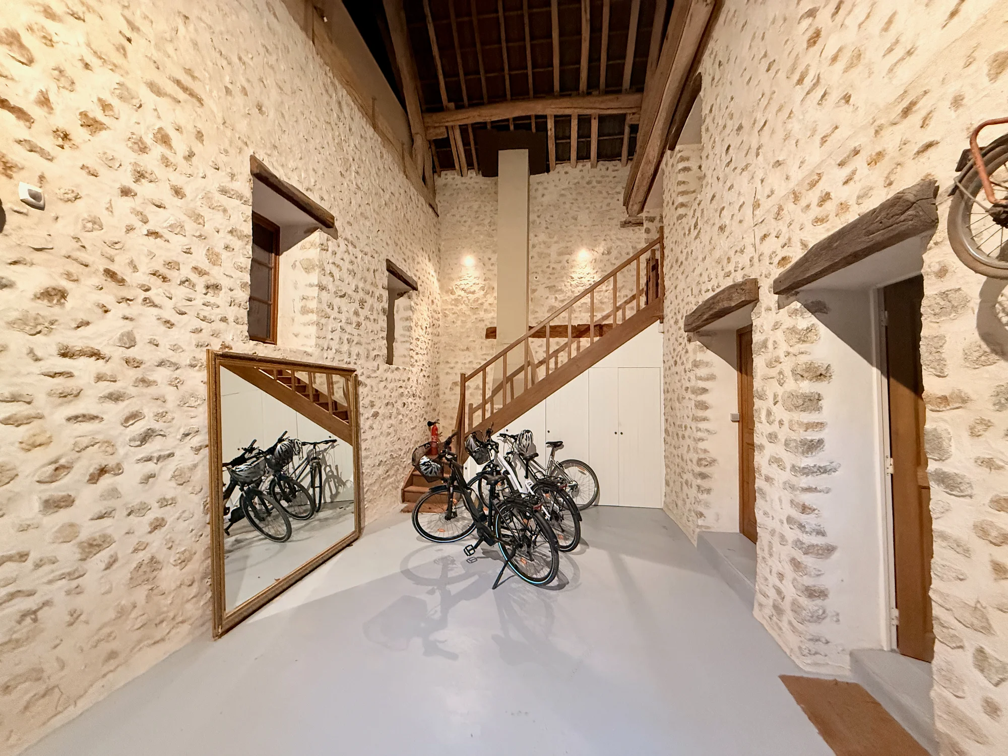 Bicycles parked in La Grange under exposed wood beams