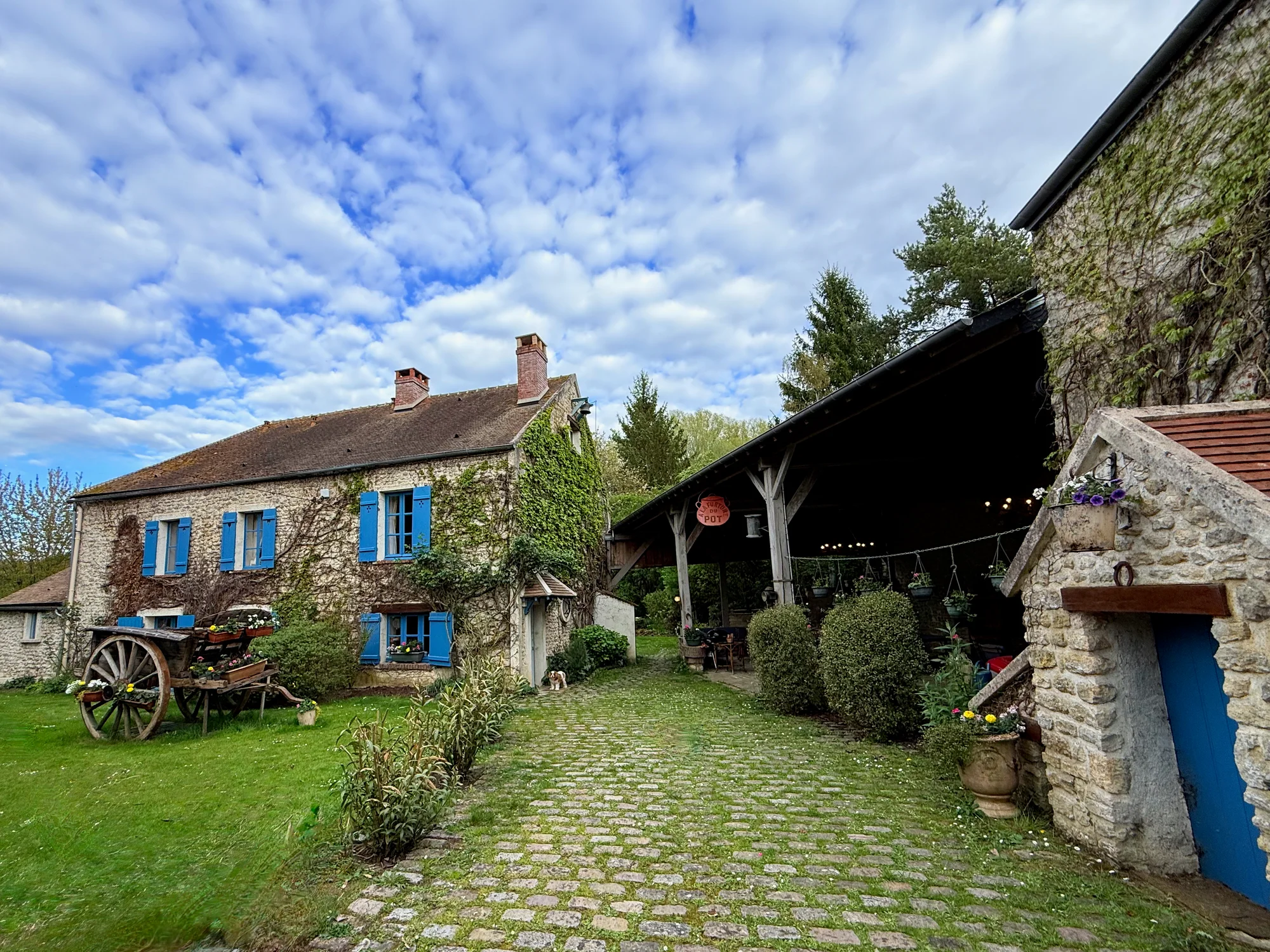 Le Moulin courtyard with the stone facade and gardens
