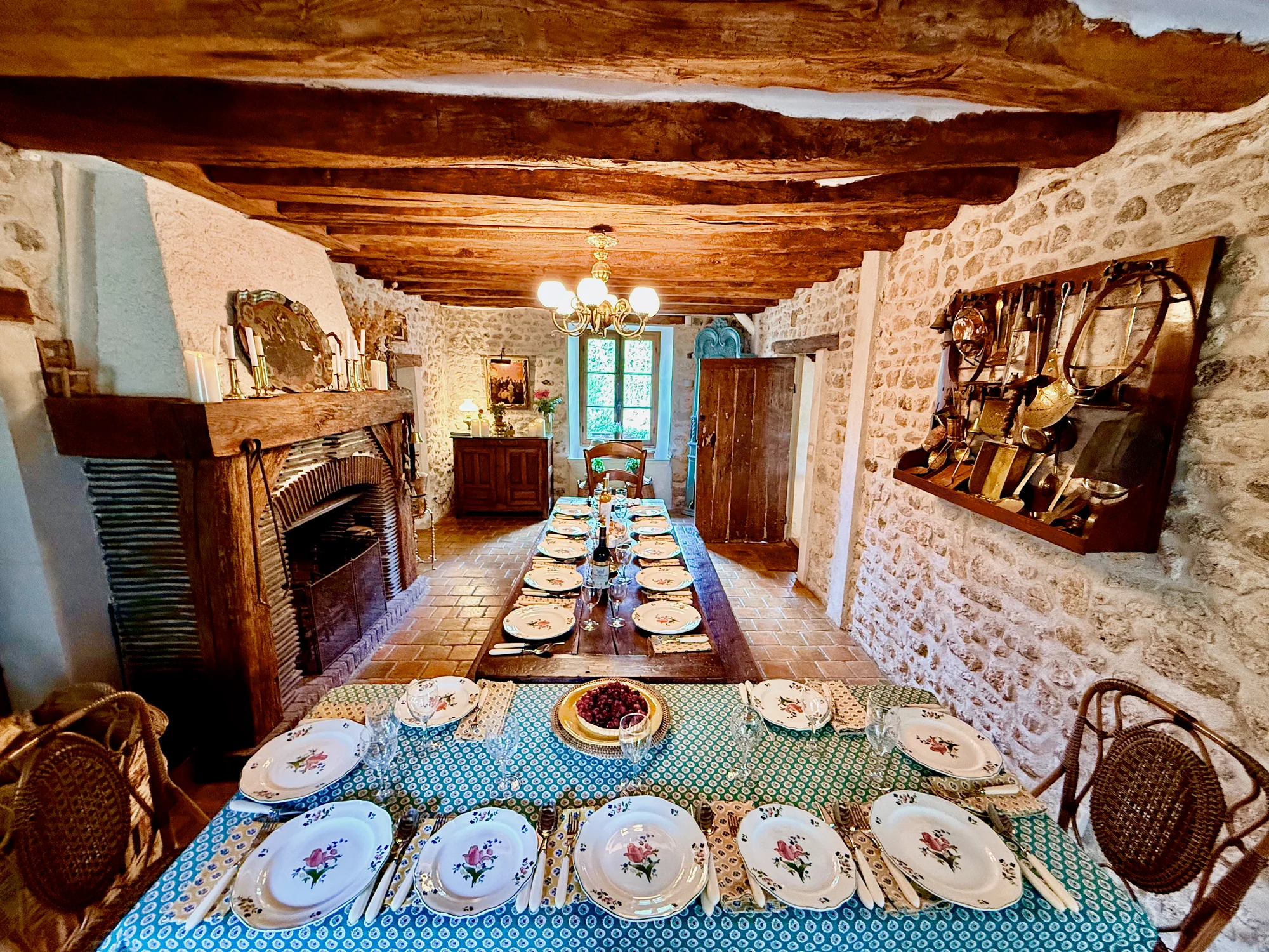 Formal dining room set for 12 with chandelier and antiques at Le Moulin