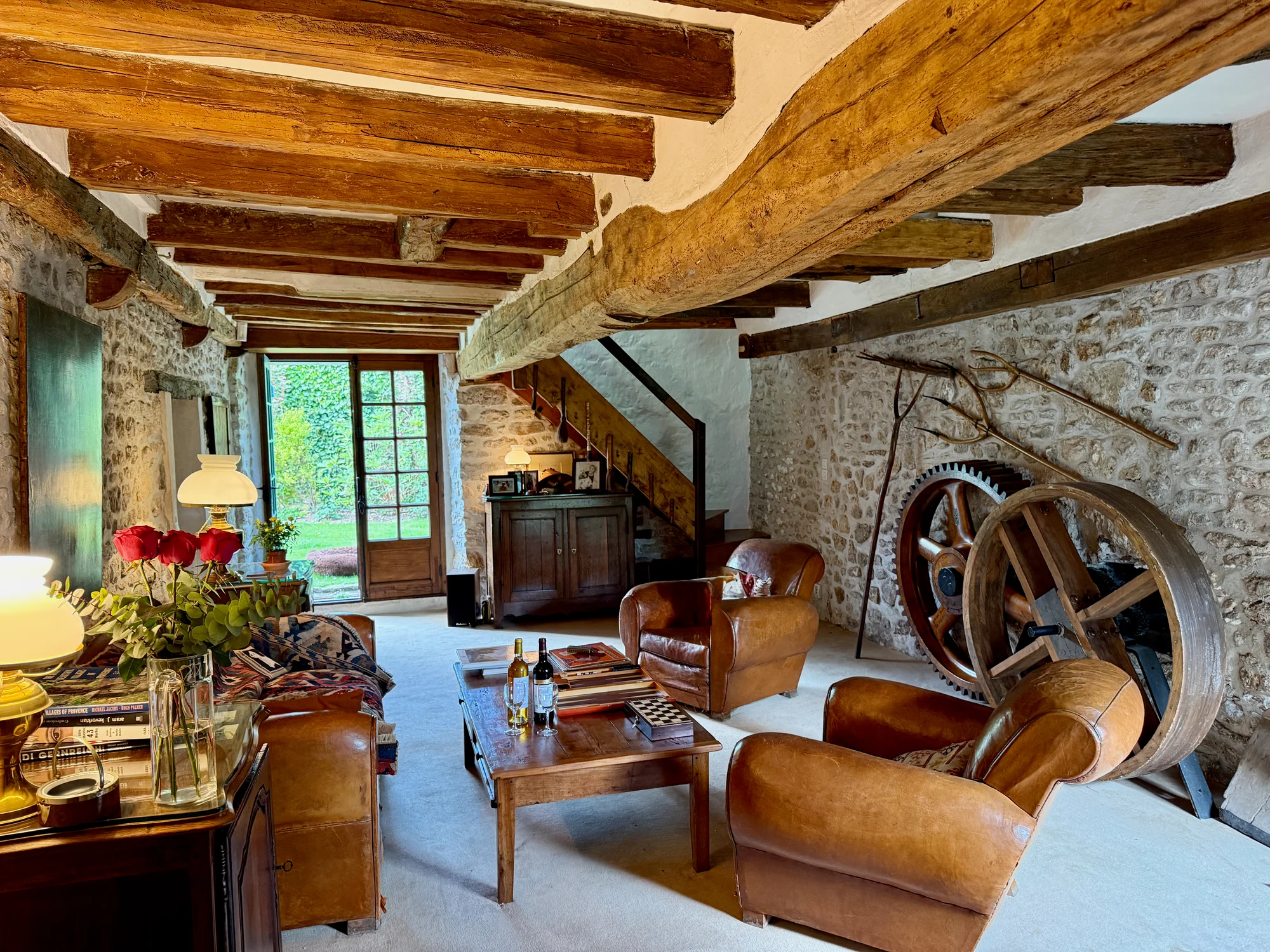 The antique water wheel from the original mill in the living room at Le Moulin