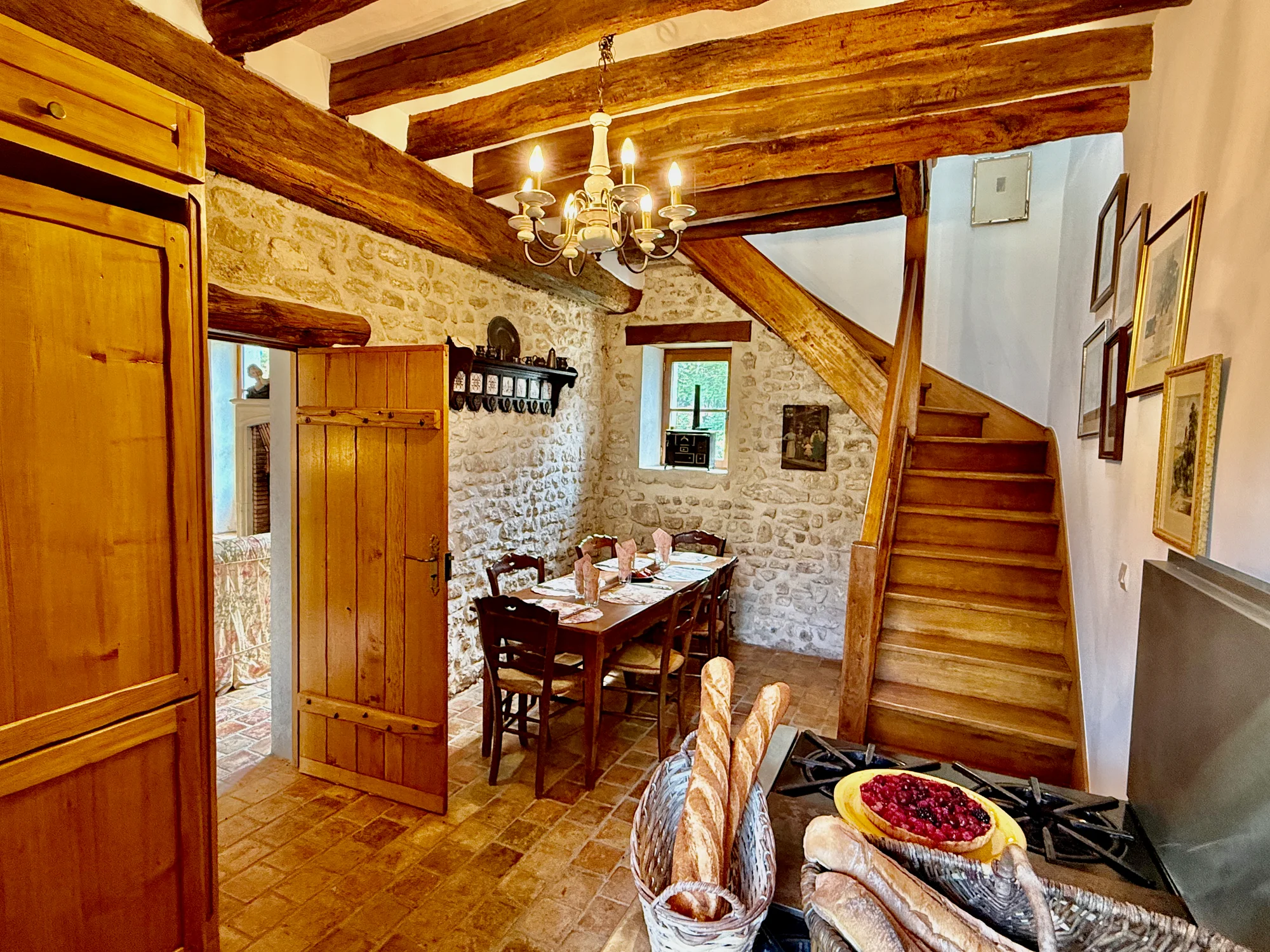 Eat-in kitchen with wooden staircase and dining nook
