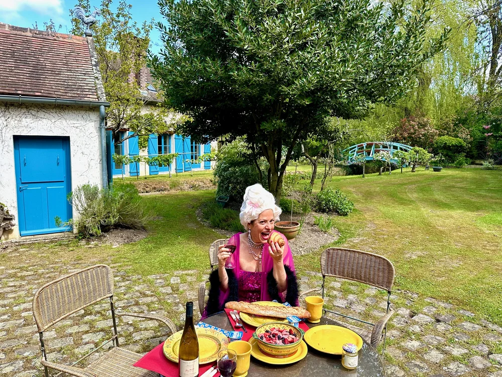 Multi-generational family dinner outdoors at Moulin à Rêves compound near Barbizon, France
