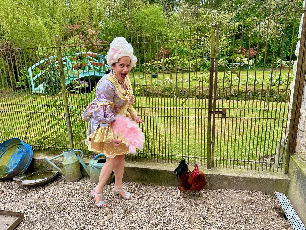 The owners of Moulin à Rêves in the garden of their French countryside compound